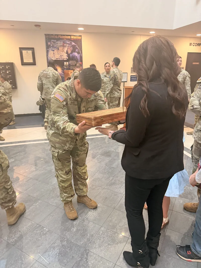 SGT Rios presents FIrst Mom with a personalized gift from the soldiers and families of HSC