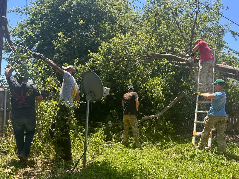 Volunteer soldiers helping remove storm debris from tornado BeltonF1